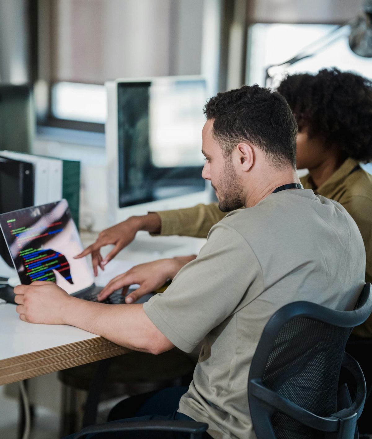 Hands typing on a laptop during a training session